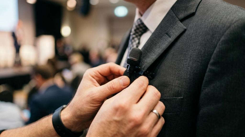 Close-up of a professional videographer attaching a microphone to a speaker's suit during a Calgary business event.